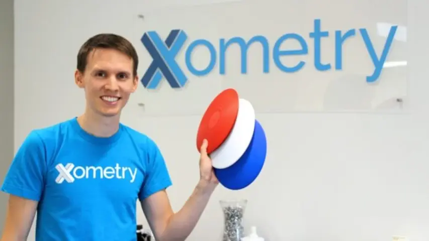 Greg Paulsen of Xometry holding what looks to be 3D printed frisbes. Greg Paulsen of Xometry holding what looks to be 3D printed frisbes.